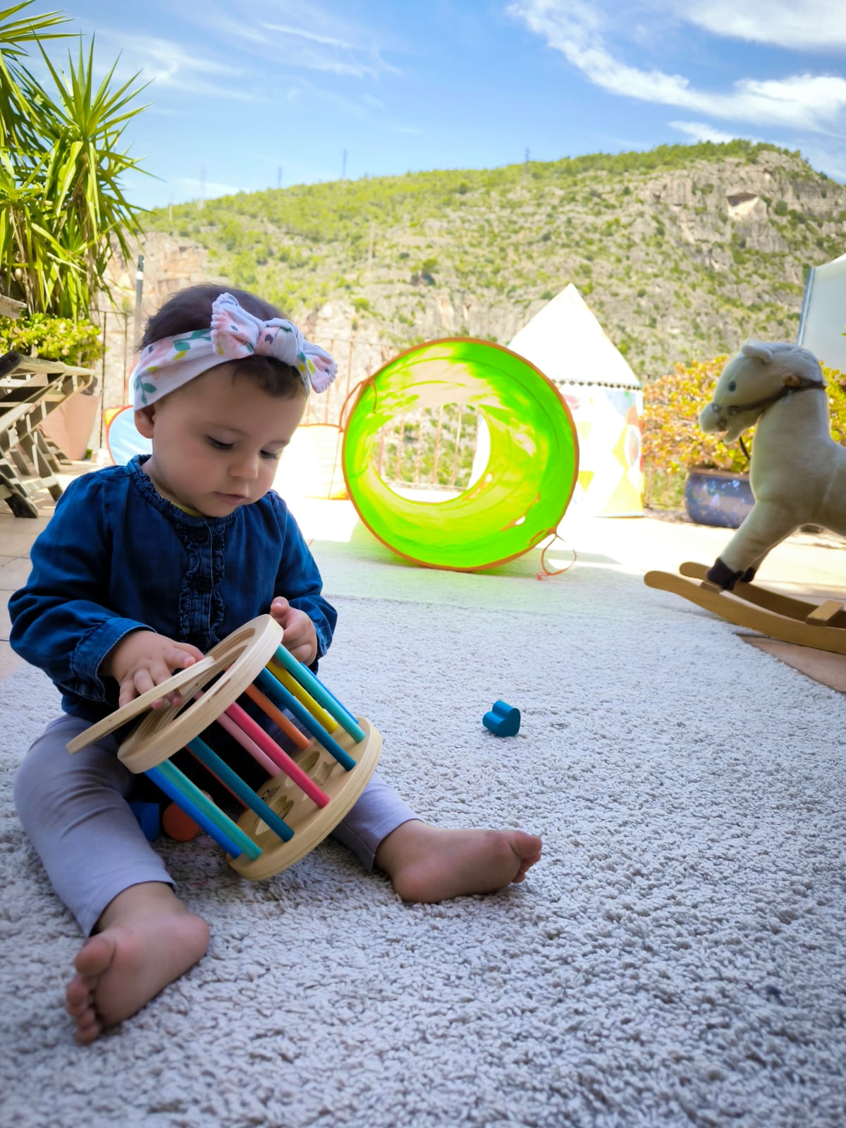 Baby with wooden toy